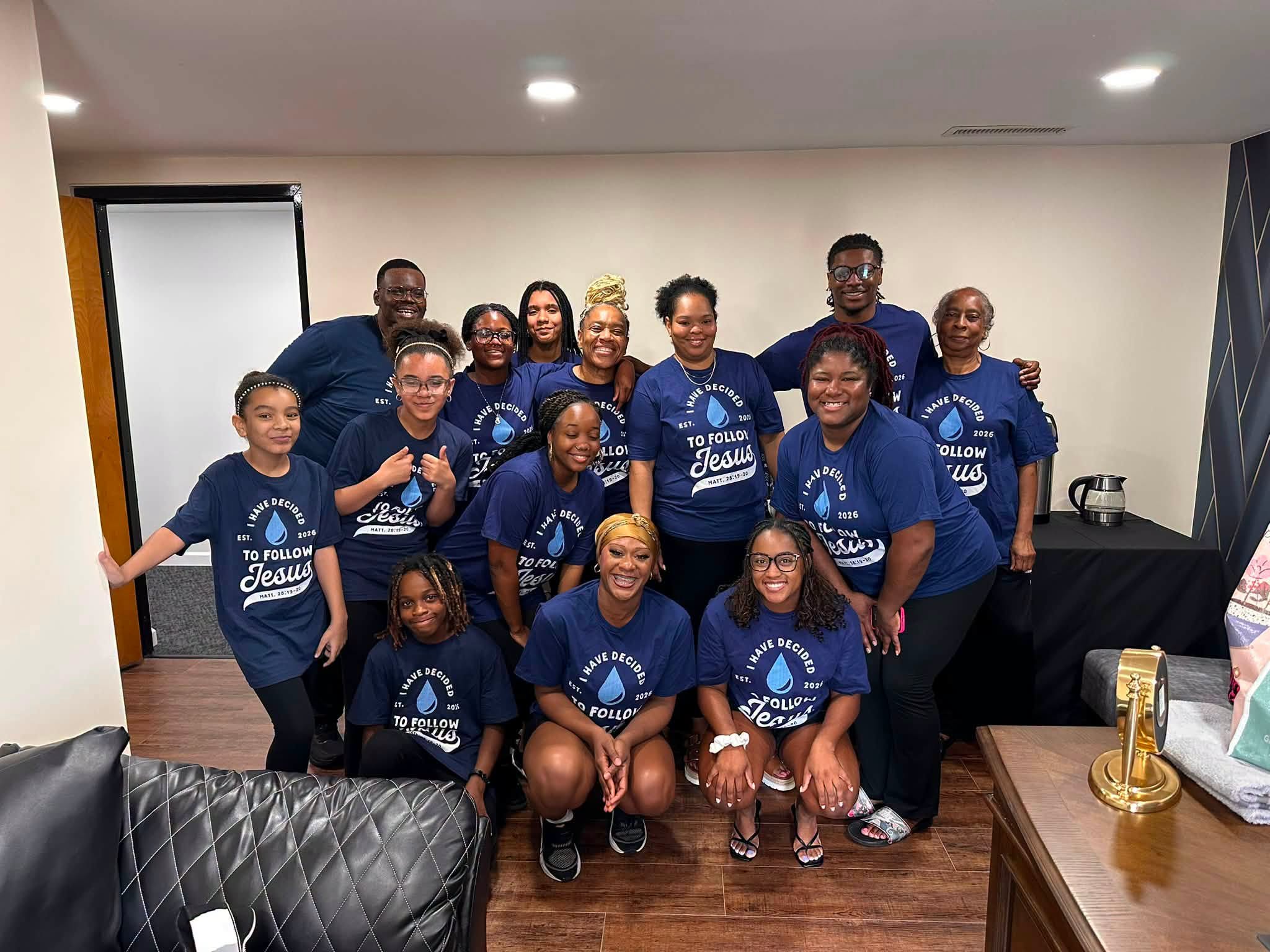 A group of members celebrating their decision to follow Jesus at Faith Family Life Church